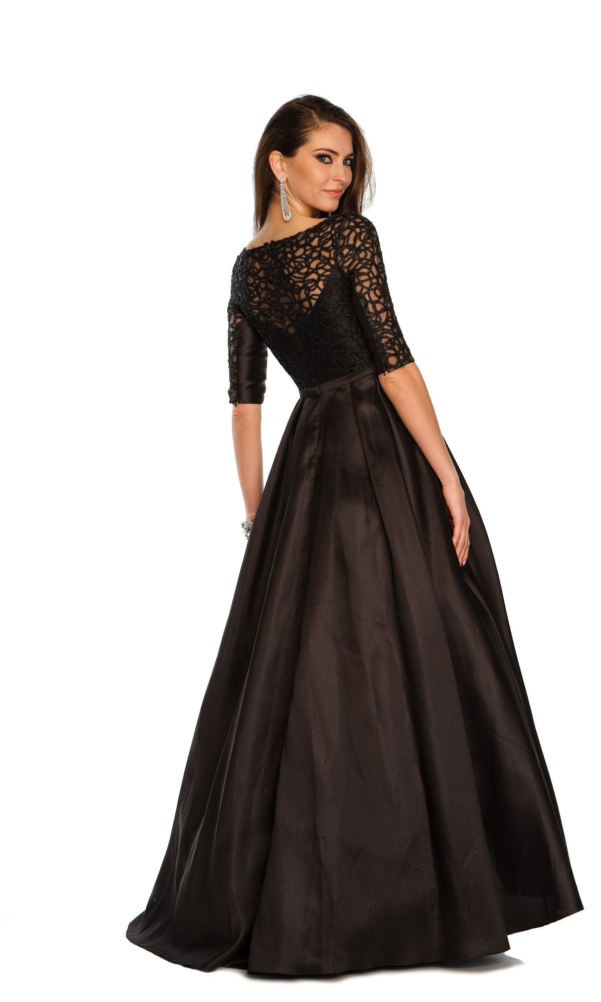 Woman wearing the Dave & Johnny 11345 Sleeved Long Prom Ball Gown with a lace bodice and three-quarter sleeves, standing against a white background and looking over her shoulder.